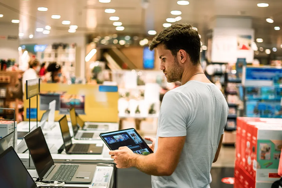 Computer store with person on a hand held